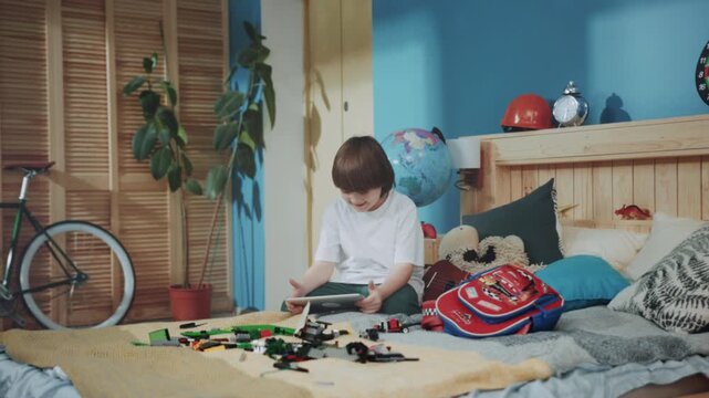 Young kid engaging with colorful building blocks, Energetic young boy stacking bricks in vibrant room environment