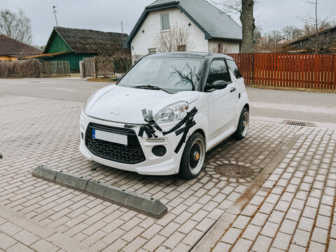 Smiltene, Latvia - April 17, 2026:Damaged Compact Car with Tape Repair Parked in Residential Area