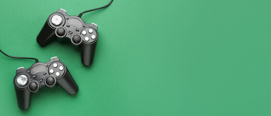 Naklejka premium Modern game pads on color background