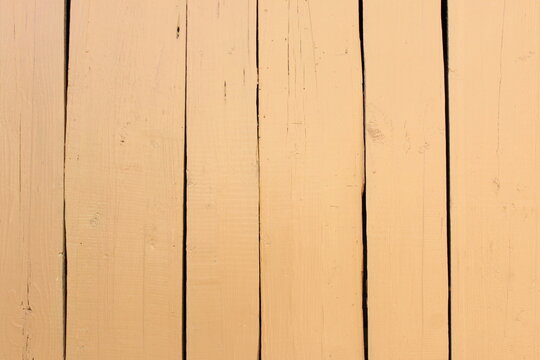 Texture of a wooden panel painted in beige color.