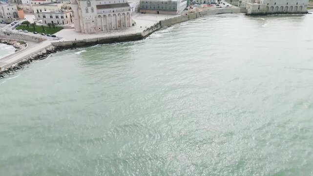 A revealing aerial shot of Trani is in southern Italy, with its famous cathedral near the sea