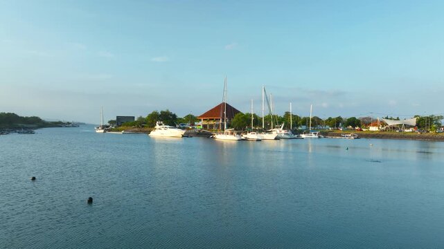 Aerial Dolly In Banyuwangi Indonesia Marina at Pantai Boom Port, Luxury Yachts and Coastal City Skyline East Java