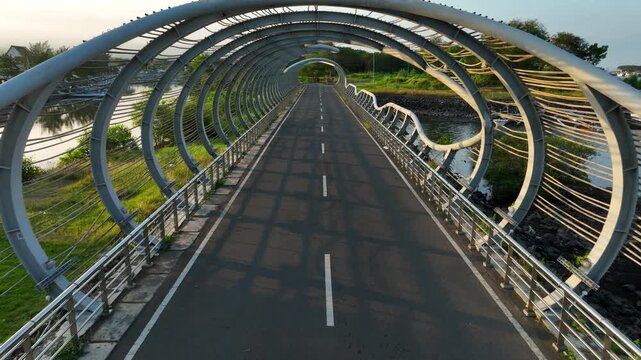 Aerial Dolly In Boom Beach Circular Bridge Banyuwangi Indonesia, Steel Landmark at Pantai Boom East Java with Green Fields
