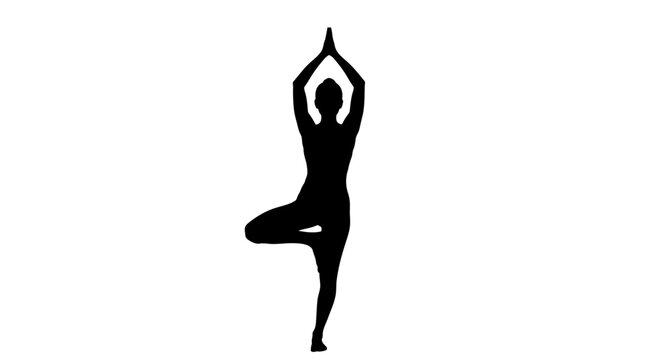 Woman in yoga tree pose standing.