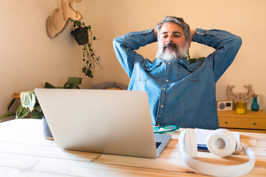 Mature man relaxing at home while taking a work break