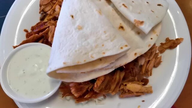 Chicken shawarma plate with rice kebab tzatziki mediterranean restaurant meal.