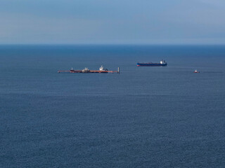 Fototapeta premium Aerial view of oil tankers next to an offshore oil transfer station