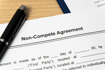 Obraz premium Legal document Non-Compete Agreement on paper close up with pen
