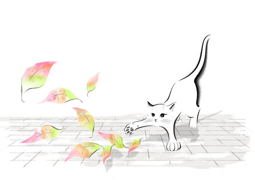 A cat playing with fallen leaves
