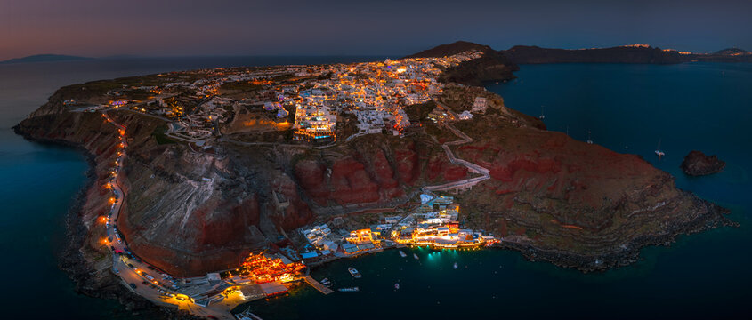 Aerial view of Oia town and caldera on Santorini island ay night, Greece. 