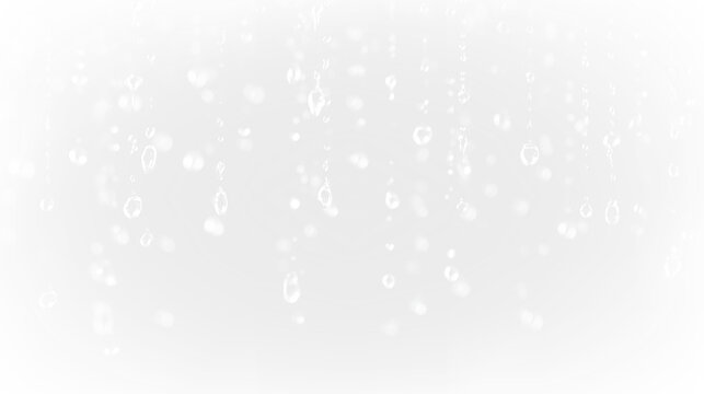 Raindrops falling on a clear background creating a textured effect with light and shadow variations