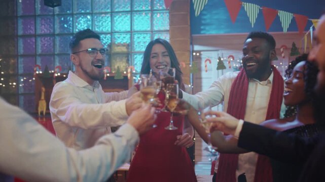 Colleagues toast by decorated tree, Relaxed gathering with smiles and cheerful conversations during holiday event