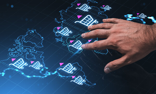 Global digital map with glowing online shopping cart icons and a hand interacting with tech interface, illustrating worldwide ecommerce concept.