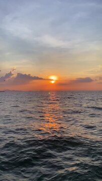 ไม่มีชื่อGolden sunset over the ocean with sunlight reflecting on water, dramatic sky and peaceful atmosphere ideal for travel, relaxation, and background design