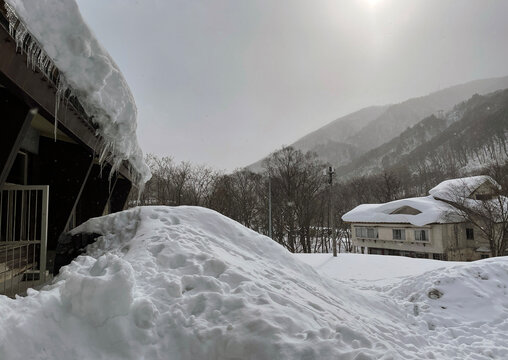 Snow covered buildings with icicles in Northern Japan