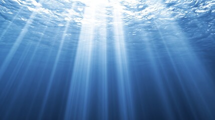 Obraz premium Sunbeams filtering through deep blue ocean water