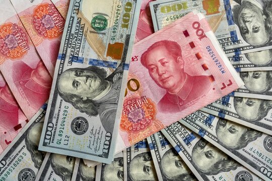 Chinese yuan and US dollar banknotes close up, international currency exchange concept