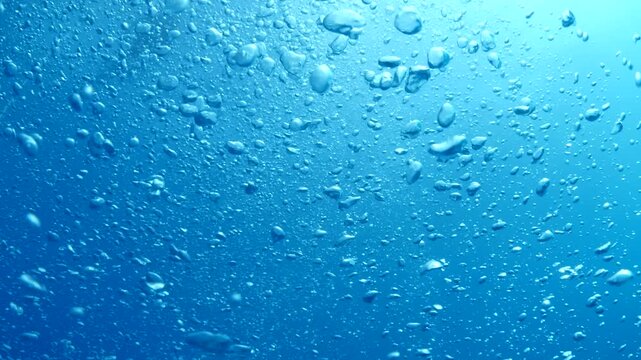 air bubbles slow  underwater coming up scenery dark blue and sun shine ocean scenery from scuba  divers backgrounds