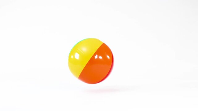 Colorful Inflatable Beach Ball Bouncing and Rolling on White Background
