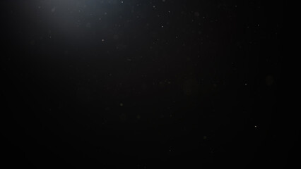 dust particles floating mid air over dark background