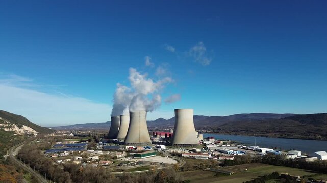 Aerial drone view of nuclear power plant in France with cooling towers and industrial landscape
