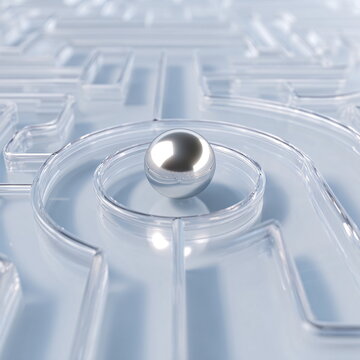 Minimalist conceptual image of a clear glass maze with a shiny metallic sphere