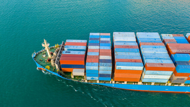 massive container ship fully loaded with colorful cargo containers sailing across turquoise ocean water. Concept of global maritime logistics, international trade, and shipping industry efficiency.
