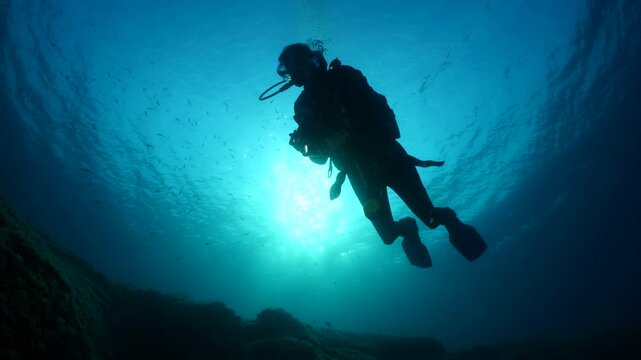 silhouette female scuba diver sun beam shine rays underwater lady woman diver relaxing blue ocean scenery of person