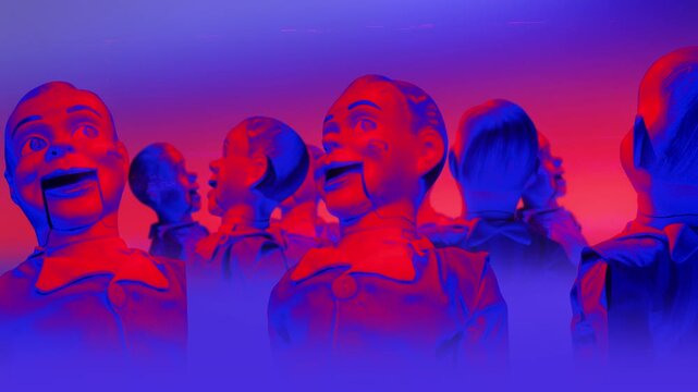 A group of faceless mannequins spinning on an endless loop in a stop motion style.
