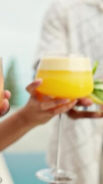 Cheers, cocktail and party with hands of friends for celebration, holiday and support. Summer vacation, bonding and toast with group of people and drinks outdoor for glasses of alcohol together