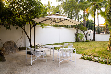 Outdoor of café shop and minimal view table desk white green environment and chair seating. Café concept. © Vahn