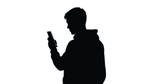 Silhouette of a man intently looking at and using a smartphone