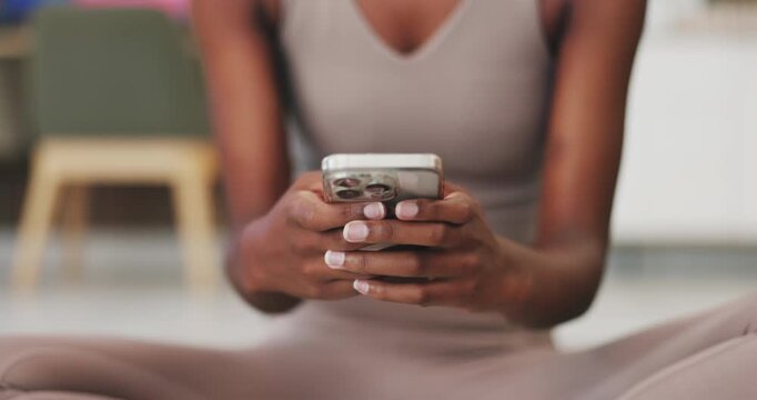 Fitness, hands and typing with phone in home for exercise break, texting and research health tips. Woman, mobile app and browsing in house for online workout guide, chat response or wellness schedule