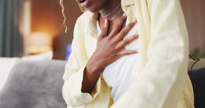 Breathing, chest pain and black woman on sofa in home with asthma, lung disease or pressure. Sick, allergies and African female person with cardiovascular emergency in living room at apartment.