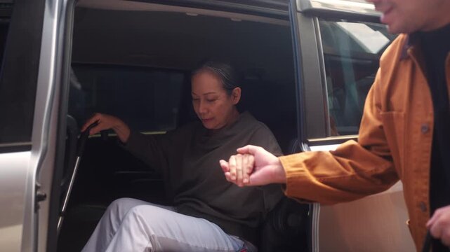 Senior woman assisted out of a car by caregiver, highlighting healthy aging, mobility support, and independent living. Reflects elderly care, active aging, senior lifestyle, and healthcare support.