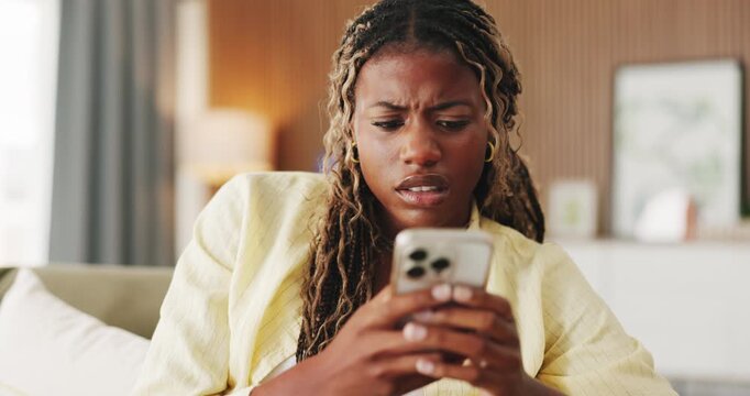 Confused, typing and black woman with phone in home for texting, networking or communication on app. Social media, bad news and female person with tech for fake website, scam or chat in living room