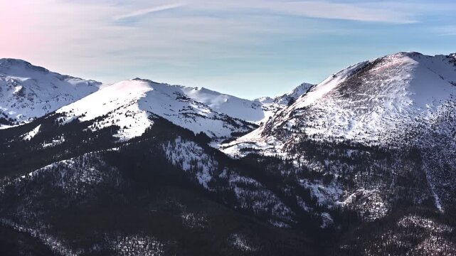 70mm zoom aerial drone shot of snowy peaks surrounding Dillon and Frisco near Breckenridge in Colorado's Rocky Mountains.