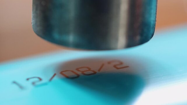 Close up detail: Thermal printer burns information onto blue PVC pipe