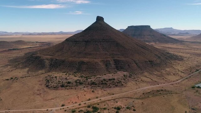 Flyover arid Karoo desert toward eroded koppie mtn called Koffiebus