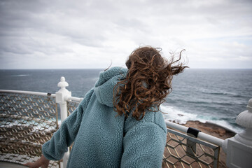 Person Enjoying Windy Ocean View From Cliff © LightItUp