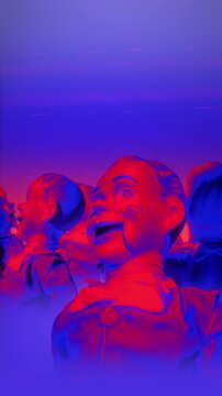 A group of faceless mannequins spinning on an endless loop in a stop motion style.
