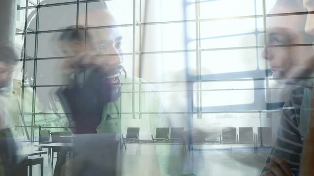 Left man beginning explanation, two men exchanging ideas for business, waiting-area ghosting chairs