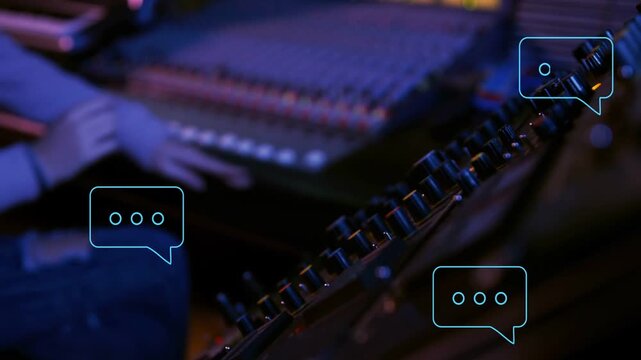 Tight closeup starting on right hand turning knobs, curly-haired operator moving faders mixing
