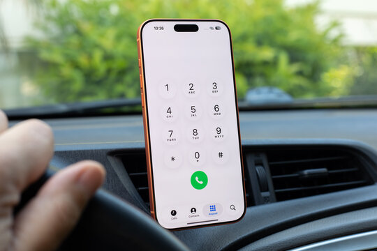 Male driver hand Phone Apple iPhone 17 Pro Max Cosmic Orange with home screen Call Phone number background Car Play