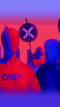 A group of faceless spinning mannequins and political statements contained on street signs on an endless loop.
