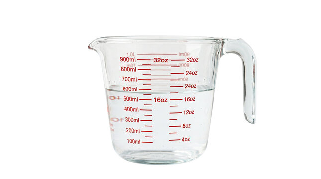 Glass measuring cup filled with liquid and markings for ml and oz on transparent background