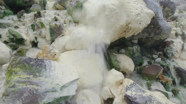 Close up view of the hot stream and sulfur sediments on the volcano of Mendeleev on Kunashir island. Russia