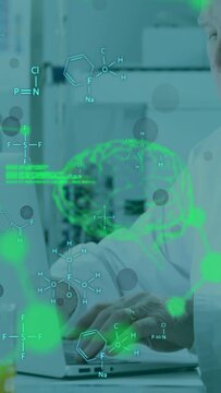 Vertical video: Senior scientist typing laptop, green overlay filling screen, analyzing brain data