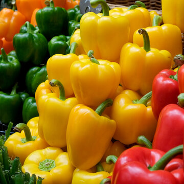 Yellow green and red bell peppers at market