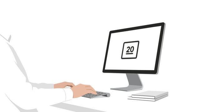 Hand holding mouse near computer screen.